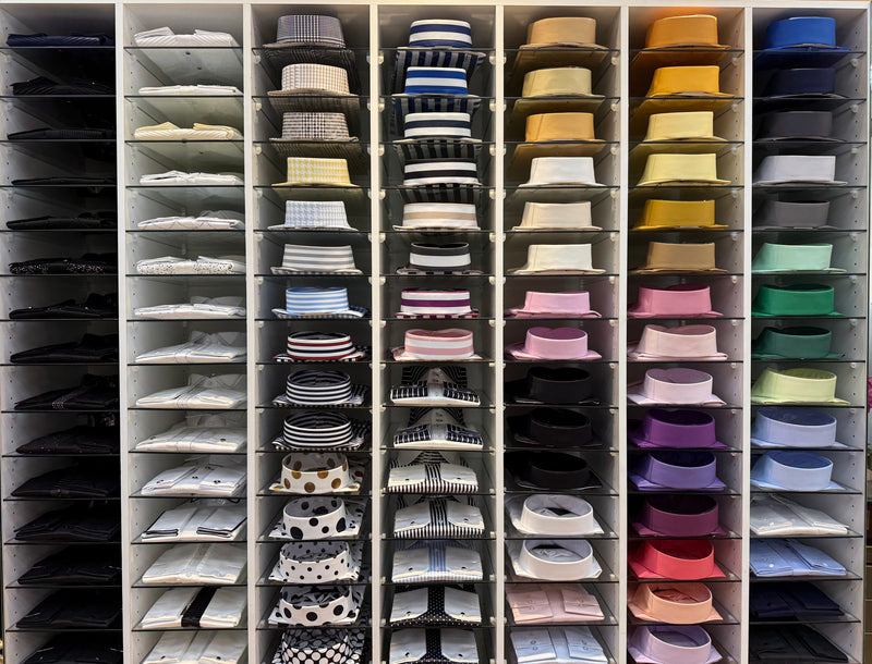 Shirts arranged by color on shelves inside the M2 boutique