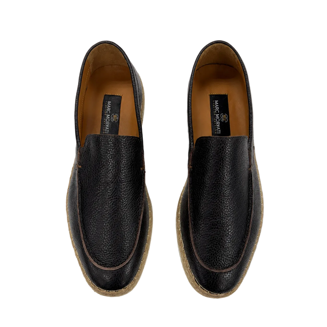 A pair of black pebbled leather slip-on loafers with brown jute-wrapped soles, shown from a top-down view on a white background. The brand name 'M2 By morvati' is visible on the insoles.